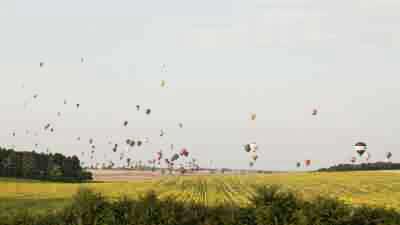 Envol de montgolfières au-dessus des champs