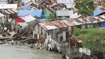L'environnement misérable de la Cité Soleil, masures aux toits de tôle et barques